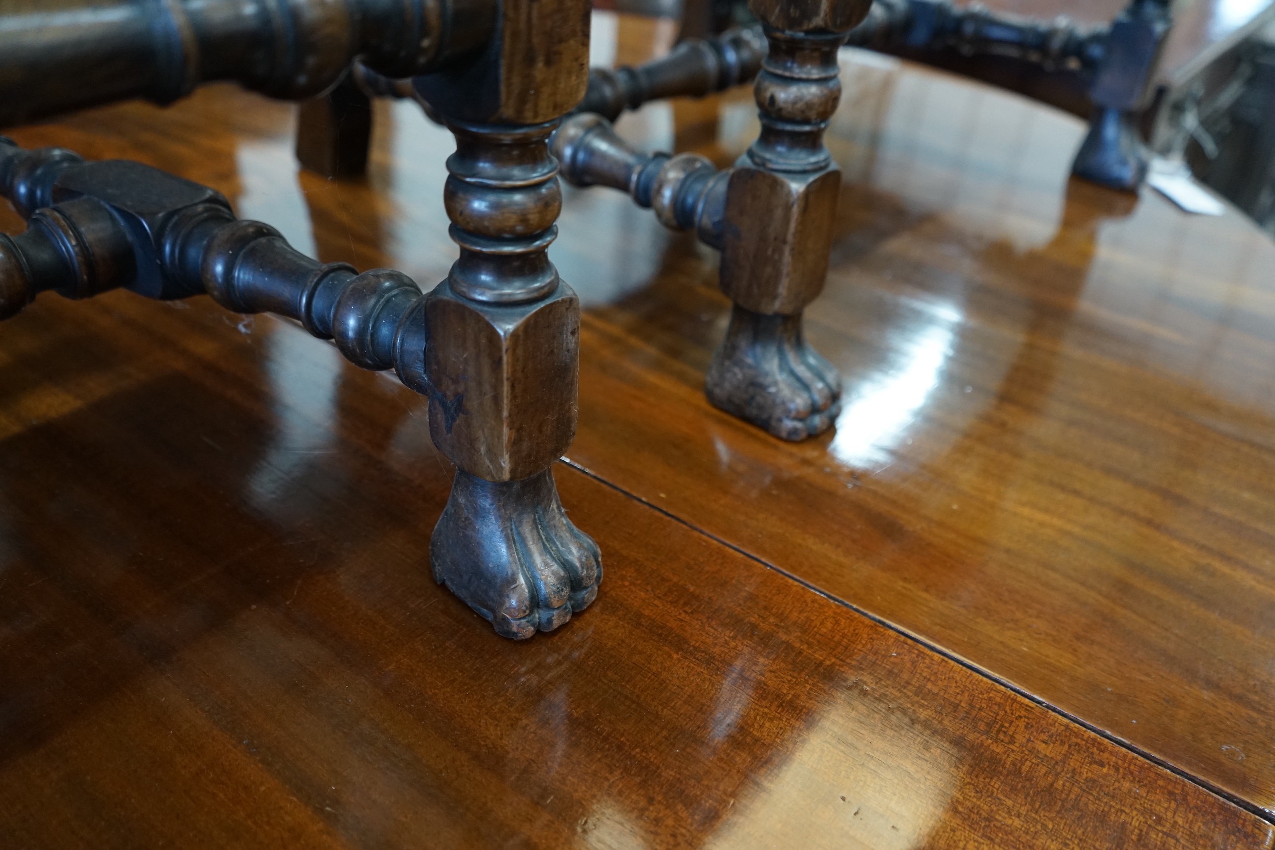 A pair of 1920's Carolean style walnut elbow chairs, width 62cm, depth 47cm, height 100cm